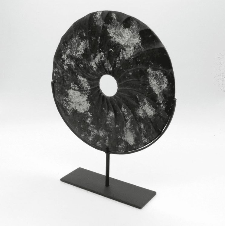black marble disc on stand