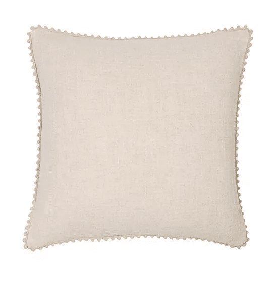 cream cushion with with small pom pom edges