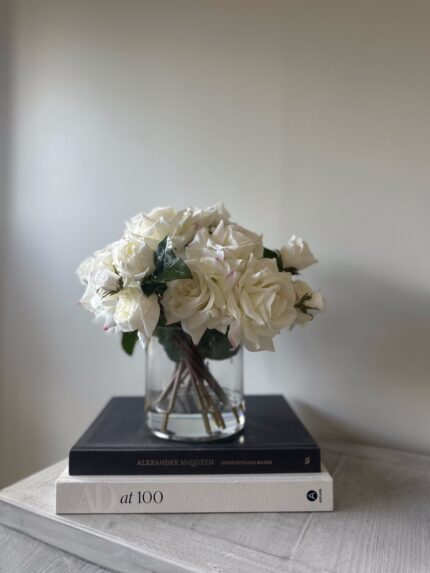 off white rose arrangement in a glass vase