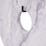 close up on the grey and lilac details of the white marble disc sculpture