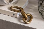 handcrafted gold chain ornament on a console table