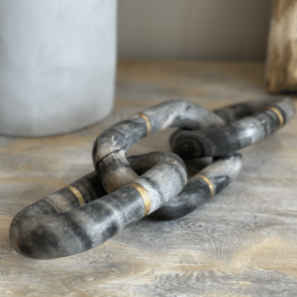 gold and cream marble chain ornament on a console table