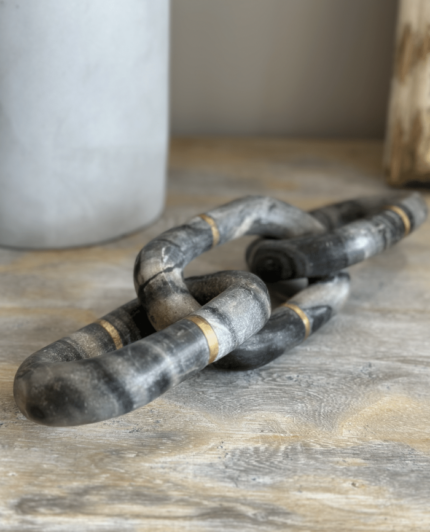 gold and cream marble chain ornament on a console table