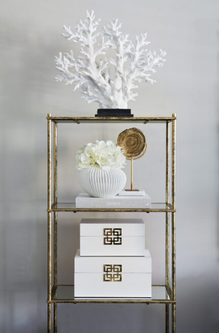 large faux coral tree ornament on shelf
