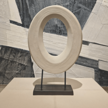 oval shaped porcelain disc sculpture on stand