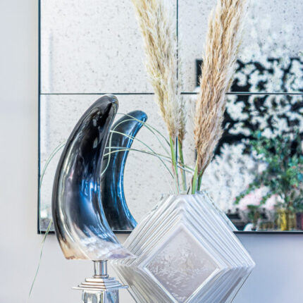polished horn sculpture on silver stand