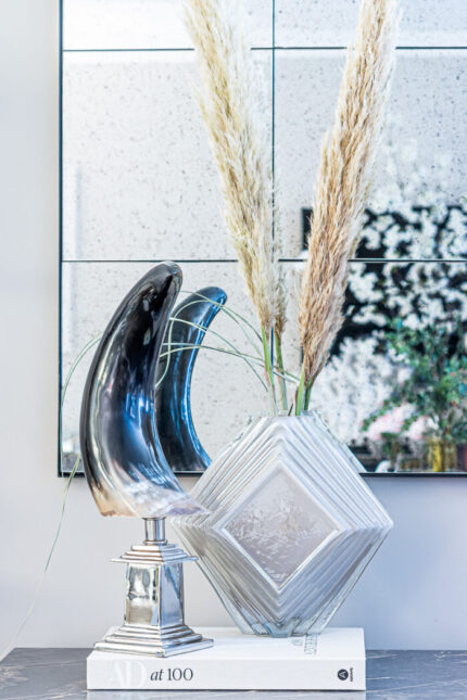polished horn sculpture on silver stand