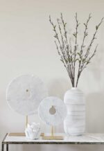 small circular disc ornament on golden stand