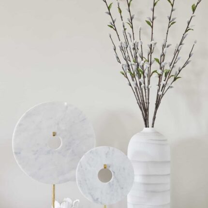 small circular disc ornament on golden stand