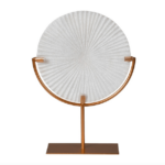 small white circular disc sculpture on gold stand