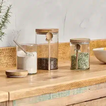 glass storage jar with wooden spoon and lid