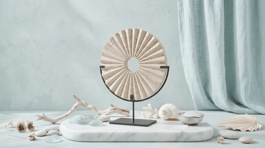 limestone round disc statue with seashell patterns studio shot