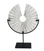 modern handmade travertine round disc sculpture on a black metal stand
